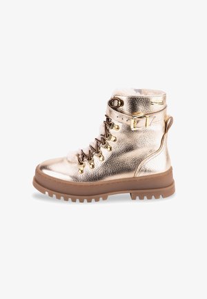 Bottines métalliques dorées à lacets avec doublure en fourrure, œillets en argent et semelle en caoutchouc brun, équipées d'une boucle sur le côté et d'une semelle épaisse.