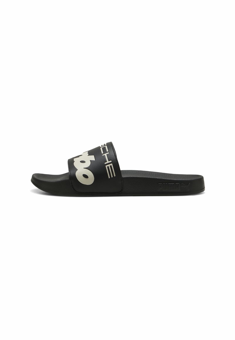 Infradito neri con una fascia larga che presenta un testo logo bianco. Realizzati in materiale sintetico, con una soletta testurizzata e una suola piatta.