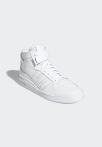 White high-top sneaker made of leather with lace-up and Velcro strap closures, featuring perforated toe and three-stripe design on the side.