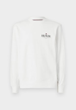 Vit sweatshirt med rund hals, långa ärmar, ribbade muddarmar och en svart Hilfiger-logga på bröstet. Mjukt tyg.
