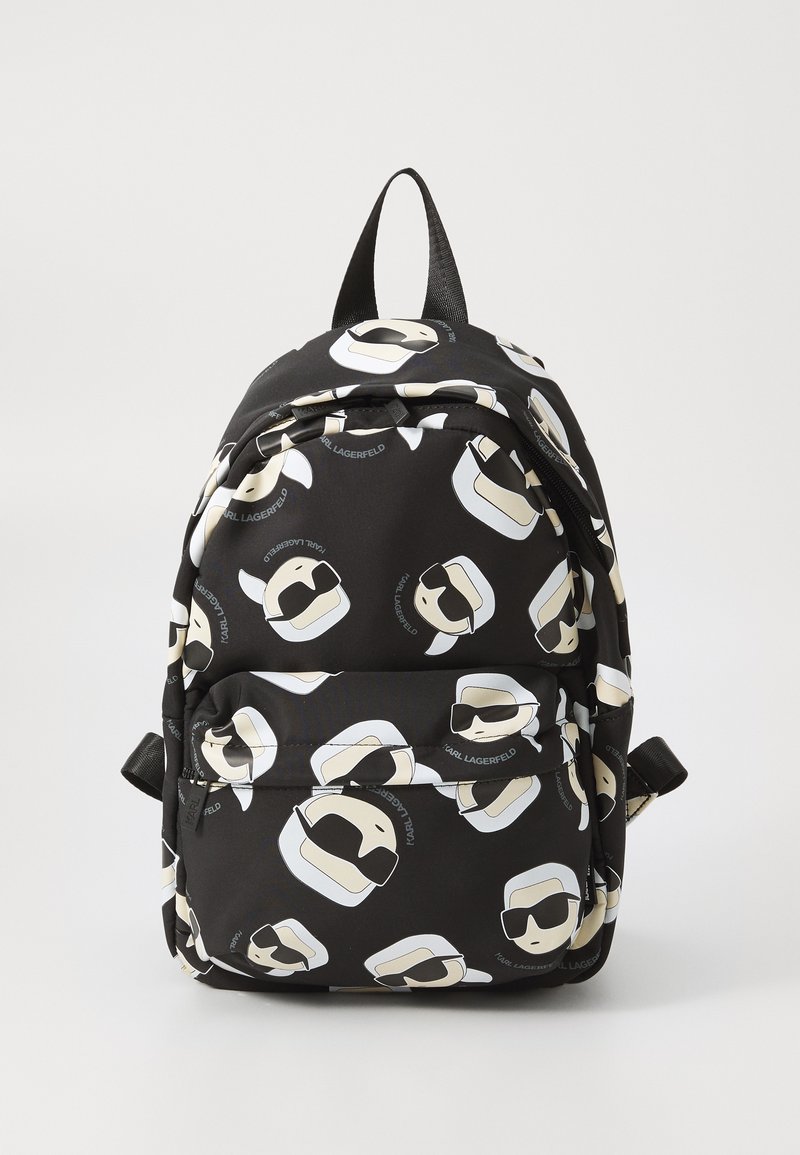 Black backpack featuring a repeating pattern of stylized white-haired figures wearing sunglasses, with adjustable straps and a zip closure.