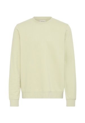 Sudadera de manga larga con cuello redondo en beige claro con puños y dobladillo acanalados, diseño sencillo, mostrada sobre un fondo blanco.