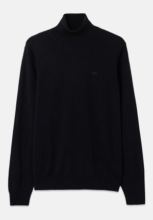Black turtleneck sweater made of soft knit fabric, featuring long sleeves and ribbed cuffs and hem. Subtle logo detail in black on chest.