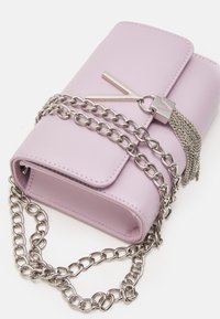 Lilac leather handbag with a metallic chain strap, silver hardware, and a tassel detail. Features a flap closure and a rectangular shape.