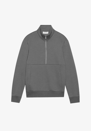 Harmaa neljännesvetoketjullinen takki, joka on valmistettu pehmeästä kankaasta ja jossa on korkea kaulus, etutasku ja ribbireunat. Yksinkertainen muotoilu ilman lisäkuvioita.