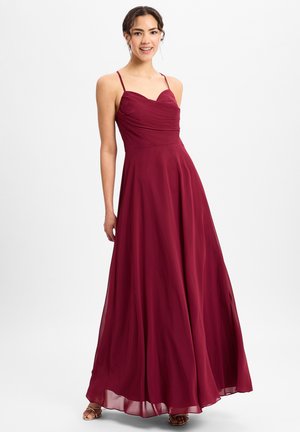 Burgunderfarbenes Abendkleid mit Herz-Ausschnitt, gerafftem Oberteil und fließendem Rock. Verstellbare Spaghettiträger, leichtes und glattes Material.