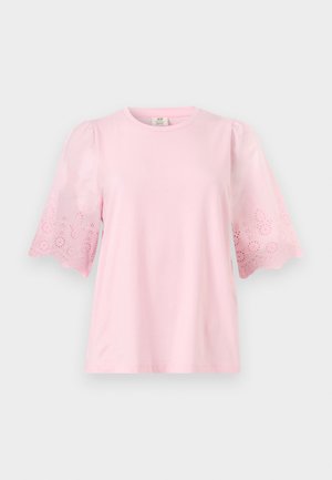 Ροζ ανοιχτό ροζ μπλούζα με κοντά μανίκια, στρογγυλή λαιμόκοψη και λεπτομέρειες δαντέλας με τρύπες στα φουσκωτά μανίκια.