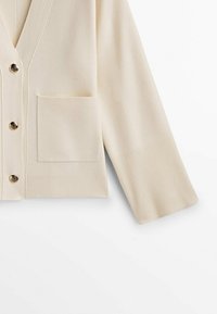 Beige cardigan with a V-neck, ribbed cuffs, and a single pocket. Features five gold-tone buttons, made from soft knit fabric.