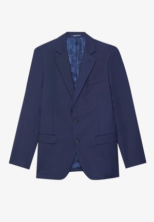 Marineblå blazer med to knapper, spisse reverser og to frontlommer. Innvendig har den et mønstret fôr. Teksturt stoff.
