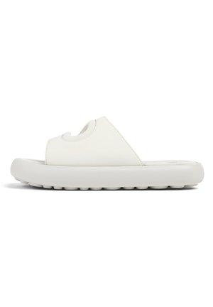 White slide sandal with a textured rubber sole, curved footbed, and wide top strap featuring a cutout design. Smooth synthetic upper material.