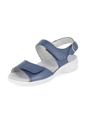 Sandale bleue à bout ouvert avec des brides Velcro réglables et une semelle blanche rembourrée, avec une boucle argentée sur la bride de cheville.