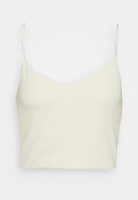 Débardeur beige clair côtelé avec fines bretelles réglables et un décolleté en V, présentant une texture douce et une coupe ajustée.