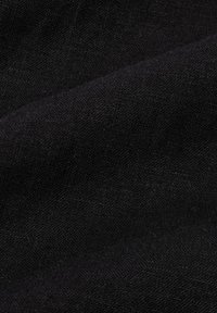 Black fabric with a textured surface, showcasing a matte finish and subtle variations in thread density. No discernible patterns or designs.