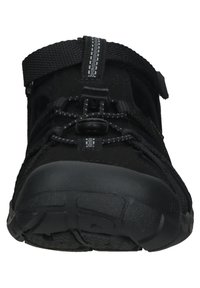 Black outdoor shoe with a mesh upper, quick-lace system, adjustable strap, and textured rubber sole. Features reinforced toe and heel.