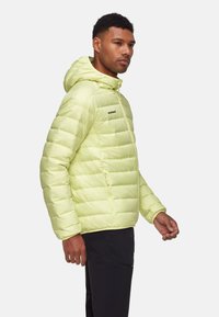 Limegrüner, mit Kapuze versehener Pufferjacke mit gestepptem Muster, Reißverschlusstasche und Logo auf der Brust. Hergestellt aus glattem, leichtem Material.