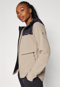 Peak Performance COMMUTER HIPE  - Impermeabile - avid beige/black
