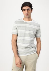 Gray and white striped t-shirt with short sleeves, crew neck, and a smooth cotton texture. Logo tag on bottom left side.