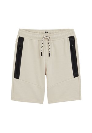 Shorts beiges mi-genoux avec taille élastique, poches verticales zippées noires des deux côtés, et cordon de serrage noir et blanc.