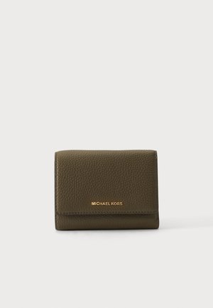 Mały, oliwkowo-zielony portfel z teksturowanej skóry z złotym logo „Michael Kors” na środku przedniego klapki, zamknięty i stojący pionowo.
