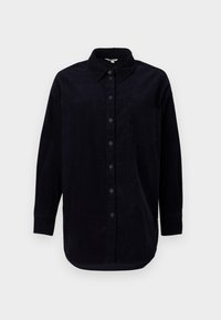 Cămașă din corduroy negru cu mâneci lungi, cu un front cu nasturi și un buzunar la piept. Are o margine rotunjită și un material texturat.