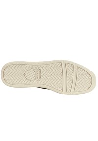 Schwarze Sneaker-Sohle mit einem strukturierten Fischgrätenmuster, aus beigem Gummi, mit einem zentralen Emblem und zwei segmentierten Bereichen.