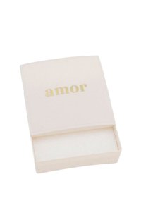 Rektangulär, mjuk-känsla krämfärgad låda med en gyllene "amor"-inskrift på locket; den har en slät yta och innervaddering.