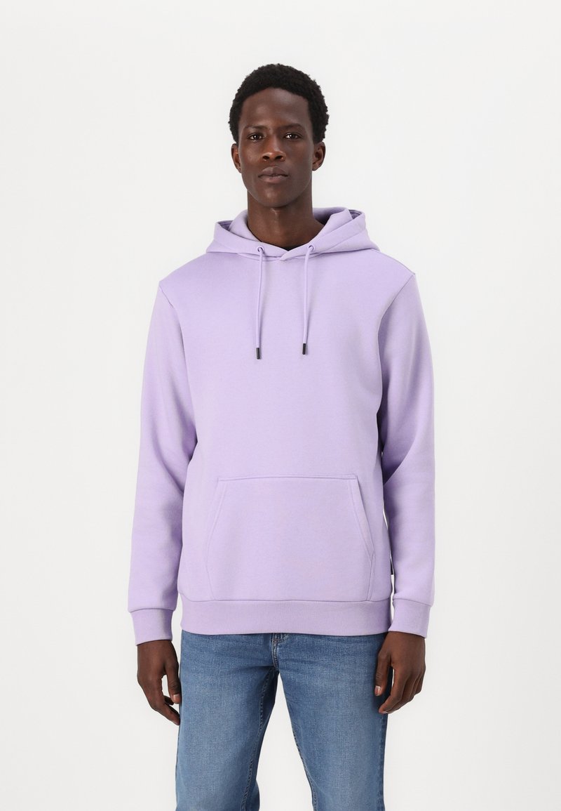 Light purple hoodie made of soft fabric, featuring a front kangaroo pocket and adjustable drawstring hood. Paired with blue jeans.