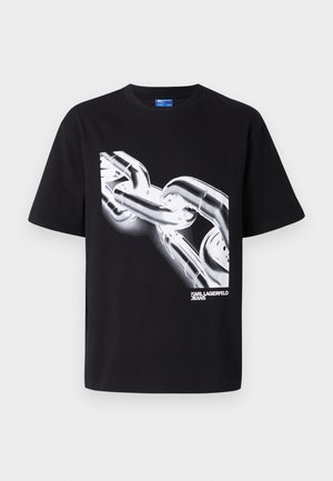 Crna pamučna majica s bijelim grafičkim motivom lance i natpisom "KARL LAGERFELD JEANS" u podebljanom, modernom fontu na dnu.