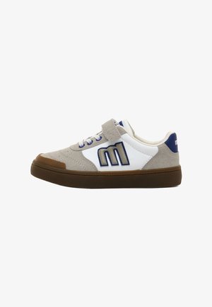 Niedrigschuh Sneaker aus beigem Wildleder, weißen Einsätzen, blauer "M"-Logos, brauner Gummisohle, Schnürsenkeln und einem Klettverschluss auf einem weißen Hintergrund.