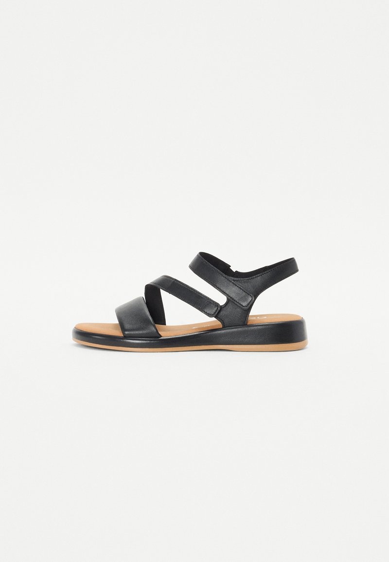Black leather sandals with three adjustable straps, a cushioned insole, and a durable rubber sole. Flat design and minimalistic shape.