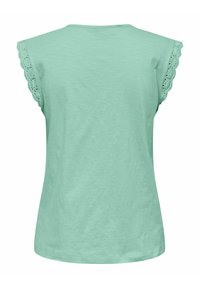 Helle mintgrüne T-Shirt mit weichem Textil, rundem Halsausschnitt und gewelltem Häkel-Ärmeldesign. Lässiger Schnitt.