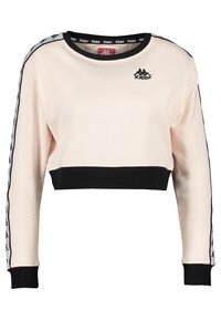 Felpa corta beige con polsini neri, fascia nera in vita, nastro con logo sulle maniche e piccolo logo Kappa nero sul petto vicino alla spalla.