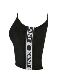 Svart tank topp med en tilpasset design som har en bred hvit stripe og "KANI"-merkevare langs midten foran. Glatt stofftekstur.