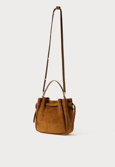 Rudas suedinė rankinė su raišteliu ir dviem petnešomis. Yra auksinės spalvos detalės ir tvirta apačia.