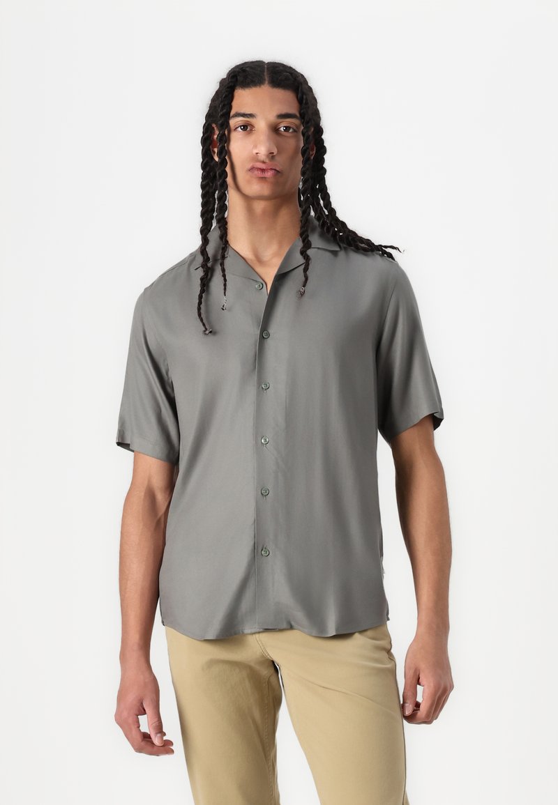 Light grey short-sleeve button-up shirt with a smooth texture, collar, and subtle sheen. Front features matching buttons and relaxed fit.