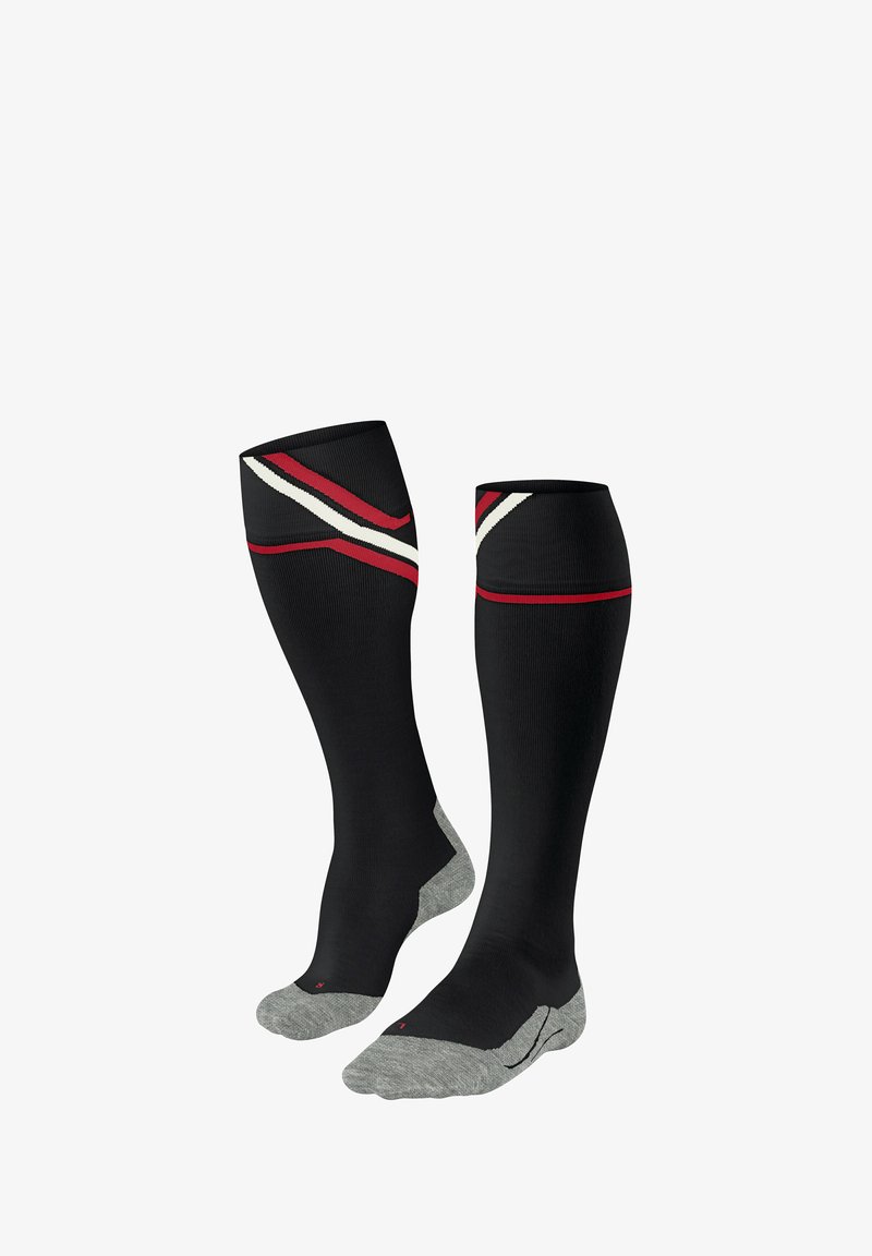 Chaussettes de compression noires avec un renfort gris au niveau des orteils et du talon. Présentent des rayures diagonales rouges et blanches près du haut. Texture lisse, design arrivant au genou.