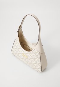 Beige handbag with floral pattern, curved shape, cream leather accents, single strap, gold-tone hardware, and interior zip pocket.