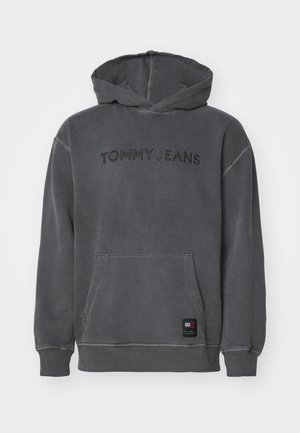 Felpa con cappuccio grigia realizzata in materiale morbido, con tasca a marsupio, dettagli cuciti e "TOMMY JEANS" ricamato in filo scuro sul davanti.