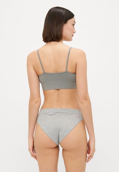 Pelēka ribota bralette ar plānām siksnām un atbilstošām augstām pantijām. Mīksts kokvilnas maisījuma materiāls ar gludu tekstūru.