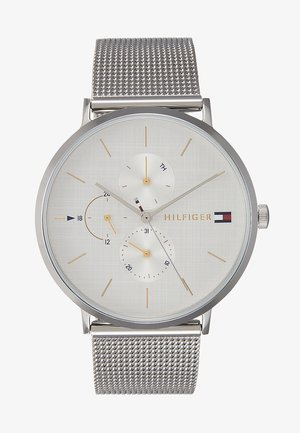 Silver watch with a textured white dial, three subdials, and gold accents. Features a metal mesh strap and a minimalist design.