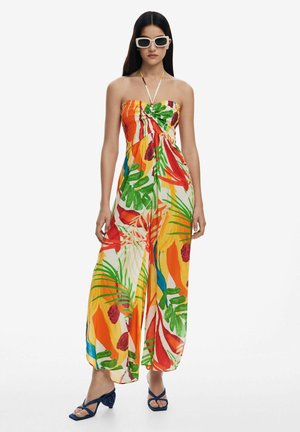 Strapless maxi dress with vibrant floral and leaf patterns in orange, green, and yellow. Made of lightweight fabric, features a tie detail at the bust.