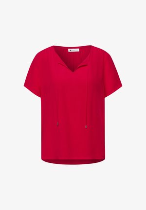 Blouse rouge à manches courtes avec col en V et cordons à nouer, coupe décontractée, et étiquette à l'intérieur du col.