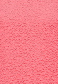Textured pink fabric covered with small, raised floral patterns evenly distributed across the surface.