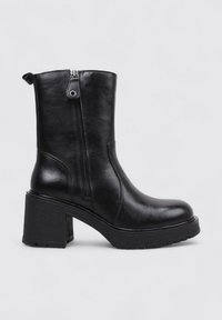 Black leather ankle boot with a round toe, side zipper, and chunky textured heel for stability. Smooth finish and minimal accents.