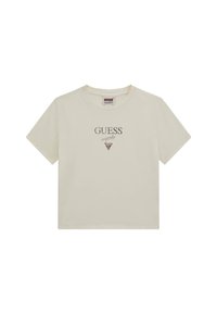 Camiseta de algodón de manga corta en color crema, con el logo "GUESS" en un estampado oscuro y un diseño triangular debajo. Cuello redondo clásico.