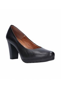 Zapato de tacón alto de cuero negro con punta redonda, tacón medio texturizado y superficie lisa. El interior presenta un forro marrón claro.