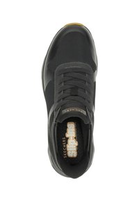 Black sneaker with a textured mesh upper, round toe, and lace-up design. Features a branded insole and subtle tonal accents.
