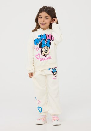 Set di felpa e pantaloni tuta color crema con una grande grafica di Minnie Mouse, dotata di un fiocco blu e cuori colorati. Texture morbida, design casual.