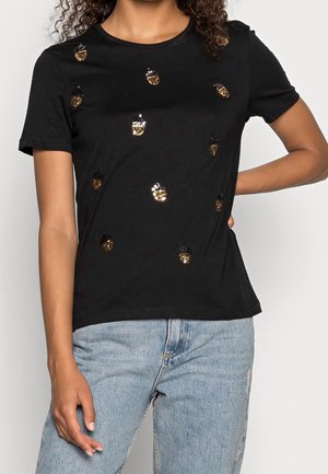 Black short-sleeve T-shirt featuring gold and black sequined acorn designs. Soft, lightweight fabric with a relaxed fit.