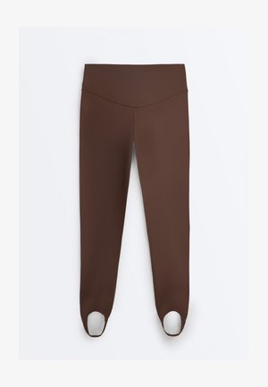 Leggings marroni a tutta lunghezza con vita alta e passanti elasticizzati alle caviglie, distesi su sfondo bianco.